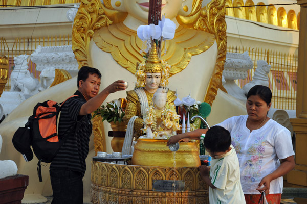 Worshipers pouring water, Shwedagon Paya