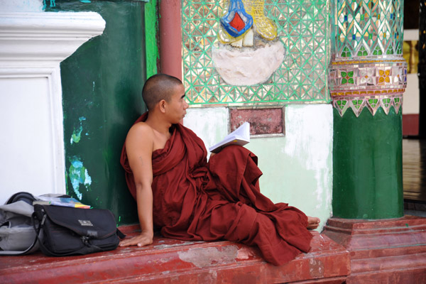 Monk relaxing with a book, Shwedagon Paya