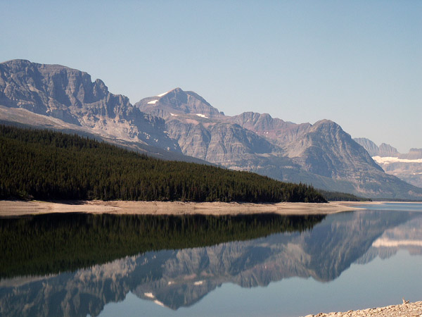 Mountains reflecting in the stillness of the early morning lake, Glacier National Park
