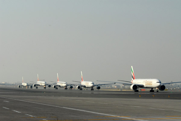 Emirates Airline aircraft lined up waiting for a scheduled pause in the Dubai Airshow