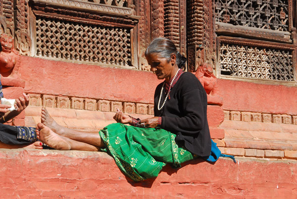 Woman sewing, Shiva-Parvati Temple, Durbar Square, Kathmandu