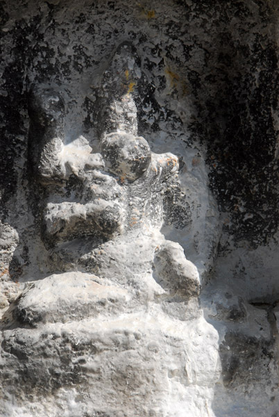 One of 108 small statues in niches around the main stupa