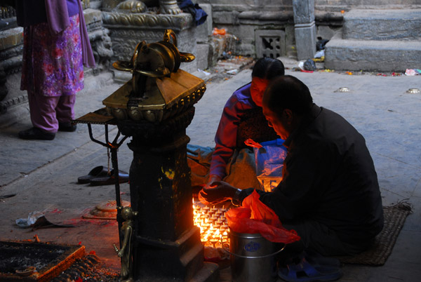 Worshippers lighting candles, Golden Temple (Kwa Bahal) Patan