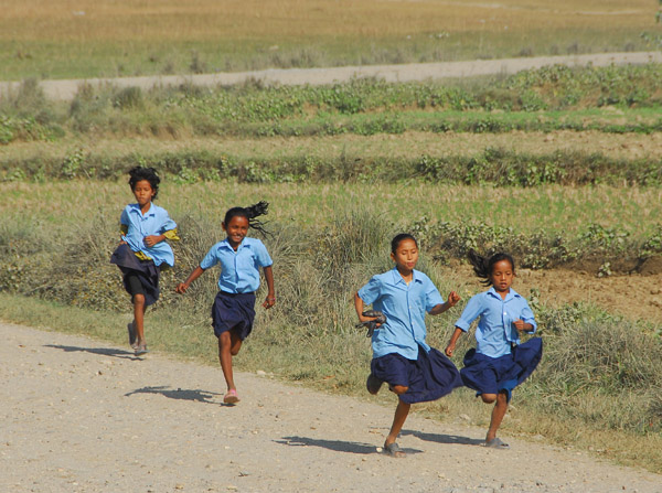 Girls running, late for school, Sauraha