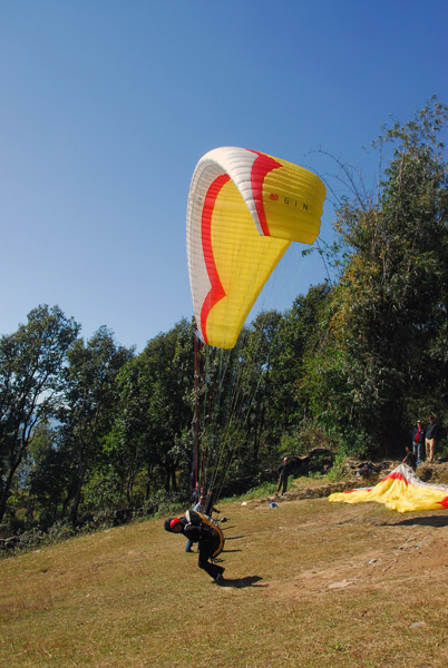 Paraglider running for takeoff, Sarangkot