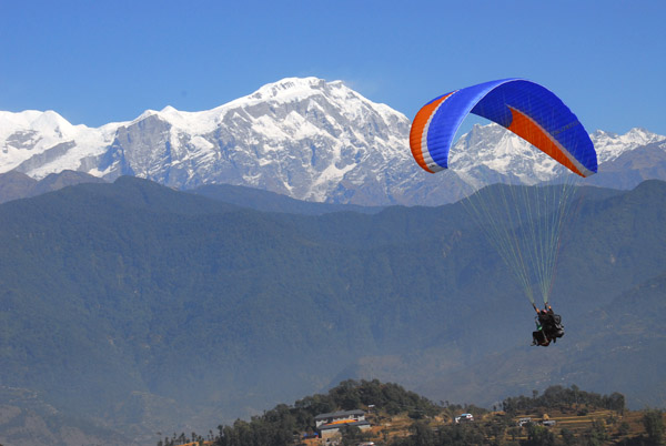 Paraglider with Lamjung Himal (6931m)