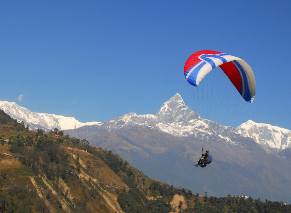 Paraglider with the Annapurna Range centered on Machhapuchhare