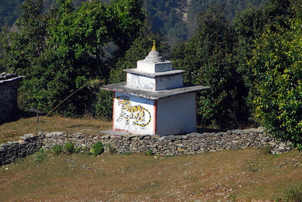 A small temple with a painted tiger on the slopes of Sarangkot