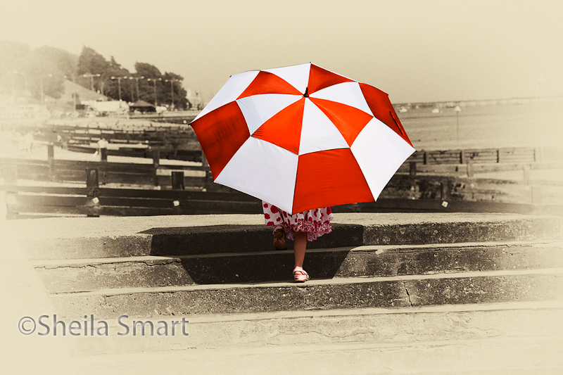 Umbrella girl on steps at Southend on Sea