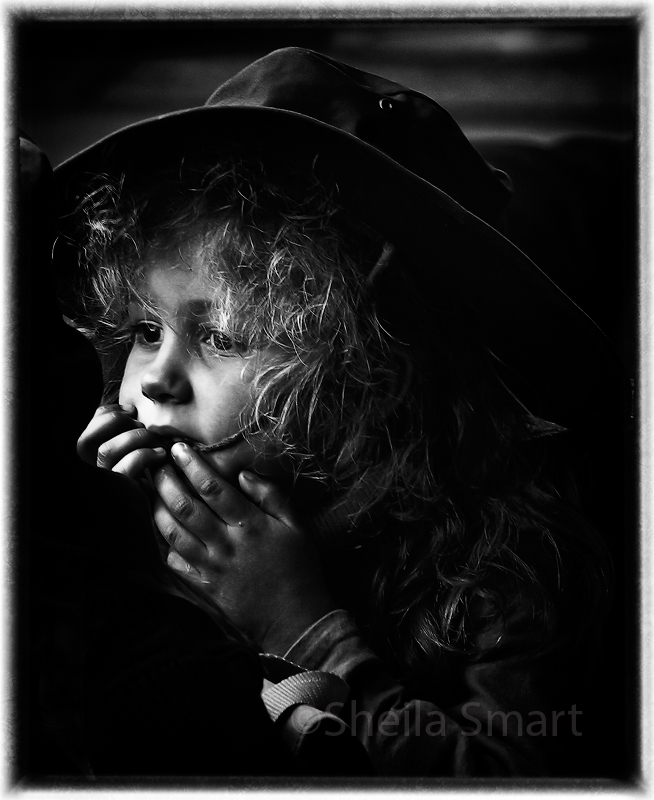 Little girl watching busker 