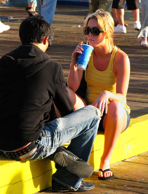 Young lovers at the Santa Monica pier: the life running behind, never stopping ...