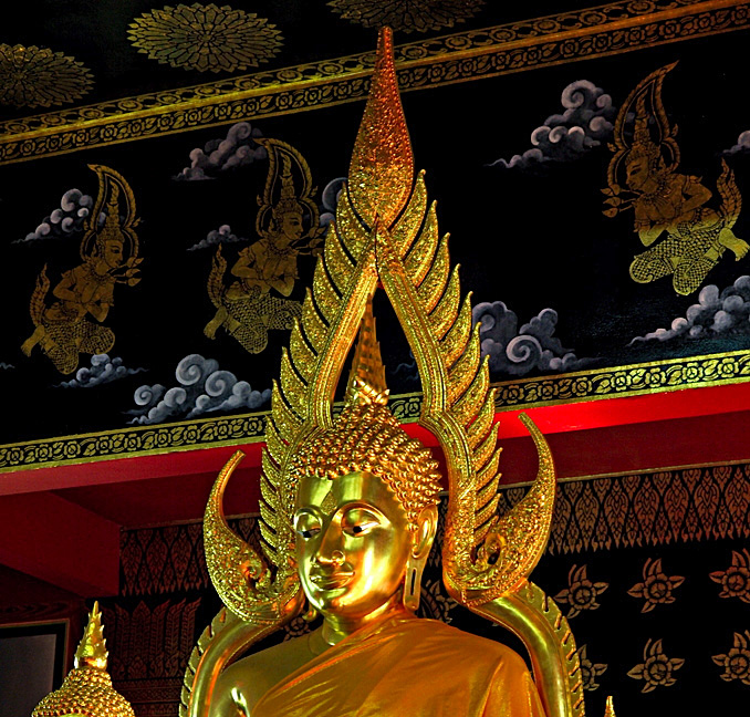 Buddha image, close up, with angels in the background