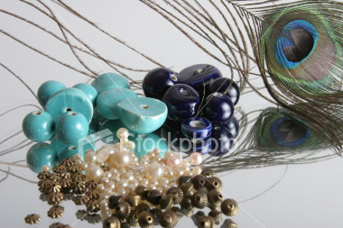ist2_1567779_glamour_beads_and_feather.jpg