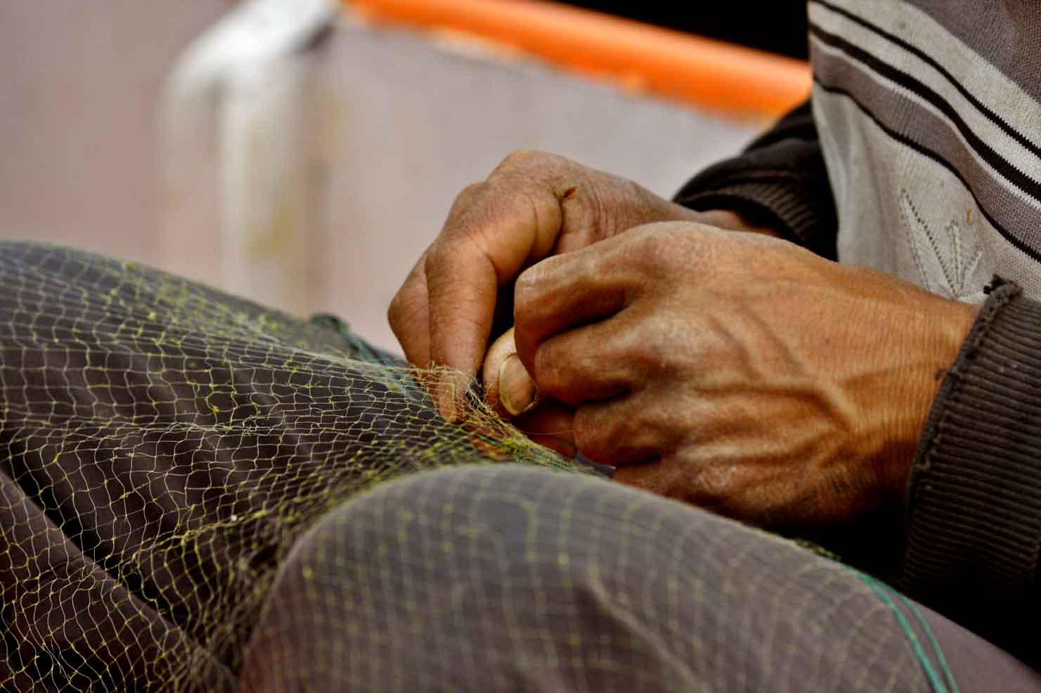 Hands of Bai fisherman repairing gill net. Dali, China. .jpg