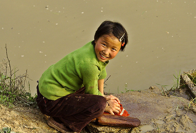 Girl washing clothes in rice paddy, Ping Shan Po Village