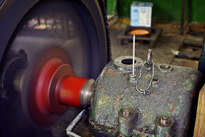 The flywheel and one of the bearings for the hydroelectrical plant. A thermometer sticks out of the bearing for monitoring.