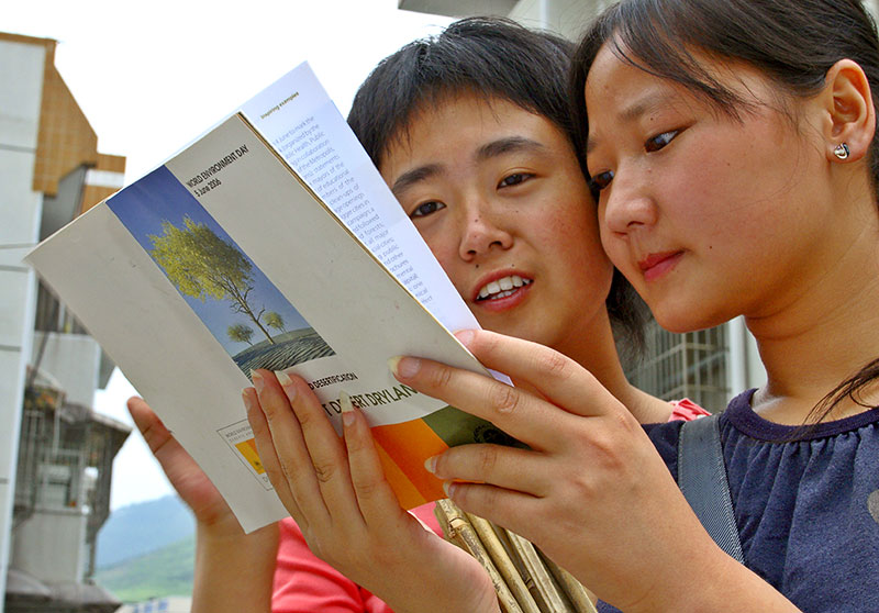 A university history major and journalist major reading about UNEP World Environment Day (WED).