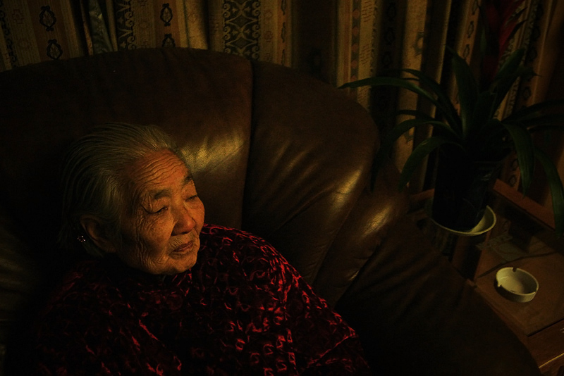 Grandma sits alone, thinking of a friend who is ill, and cannot be with her.