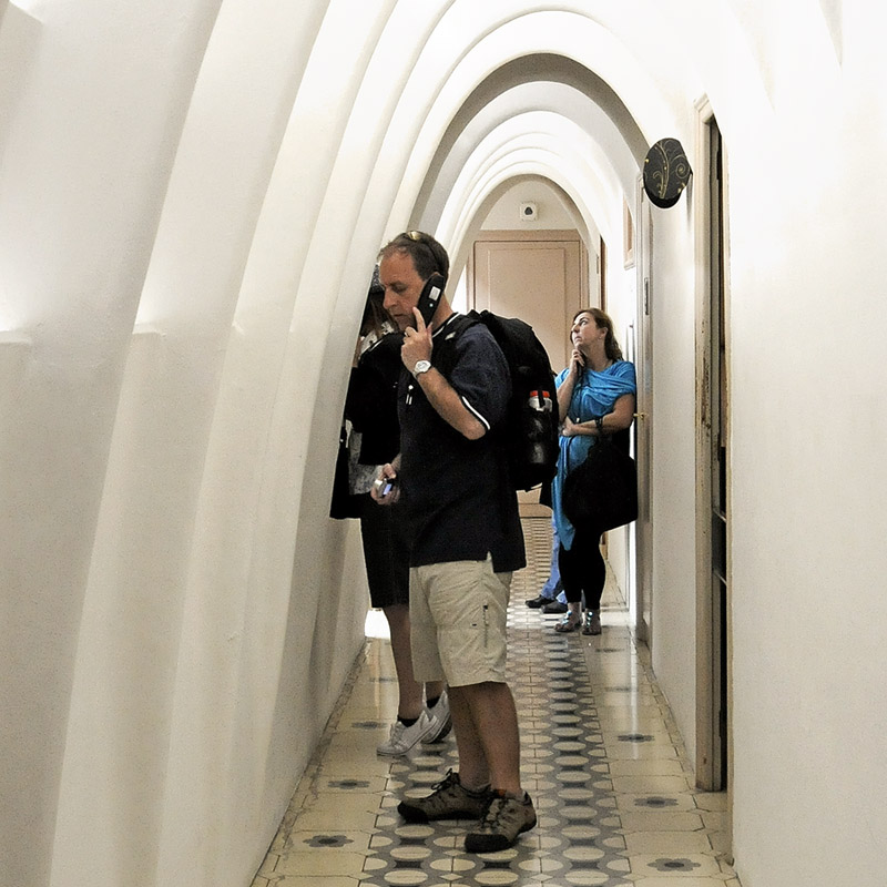 within the house of Gaudi, the tourists listen to the words