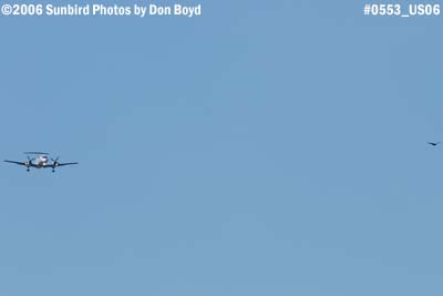 Gulfstream International EMB-120ER N261AS doing practice approaches over Miami Lakes with a turkey buzzard stock photo #0553