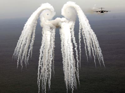 USAF C-17 Globemaster III leaves a smoke angel releasing flares over the Atlantic