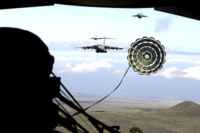 USAF C-17 Globemaster III extraction chute opens over the drop zone