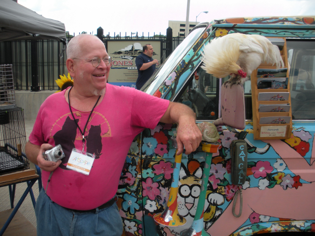 Artscape 2009 in Baltimore ... A senior hippie stands next to his chicken.