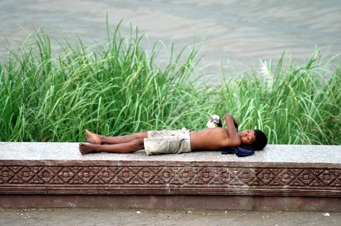 Napping on the Sisovath Quay, the riverfront promenade.