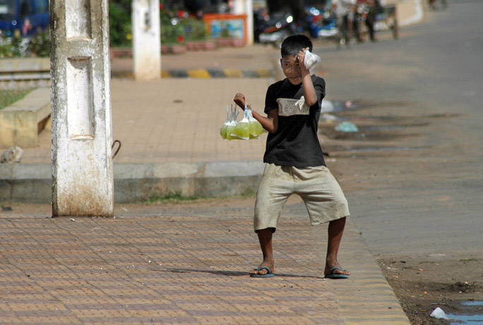 Dancin' in the street. He's selling a deliciously sweet lime drink, only 500 riels a bag.