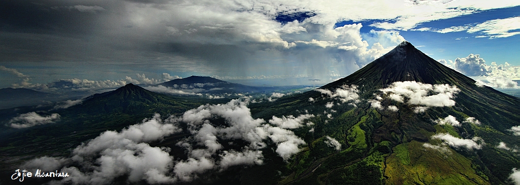 Sun and rain over perfect Mayon volcano (aerial)