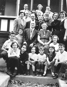 Family party (mother's side) for cousin Phyllis' (dark dress) 16th birthday. Richard is on the left - 2nd row. (1954)