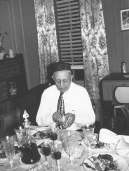 Grandpa Charles (father's side) opening his prayer book. Passover seder at grandparents' apartment in the Bronx (1949)