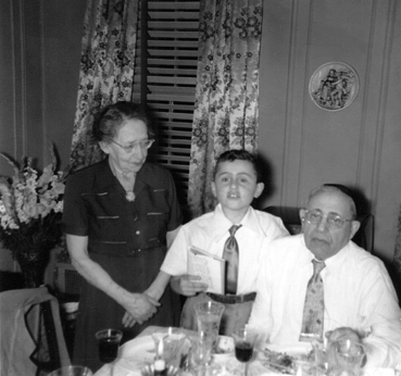 Richard with grandparents Gussie and Charles (fathers side) at a Passover seder at their apartment  in the Bronx. (1951)