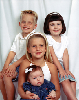 Grandchildren: Tyler and Hallie (top row) and Abbey holding Addy