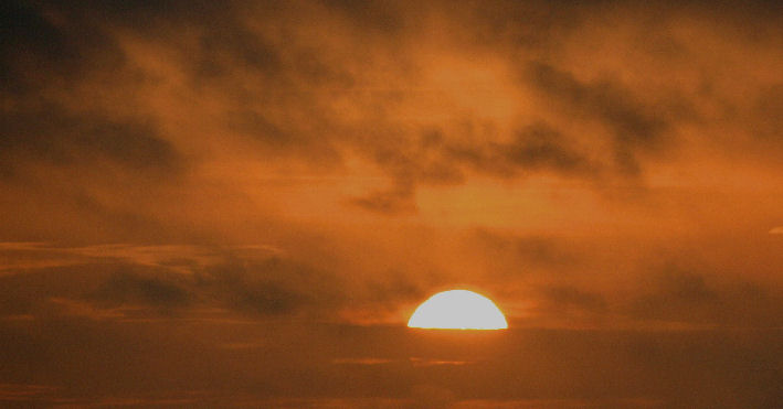 SUN RISING FROM A CLOUD