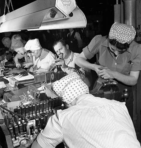 Male and female workers preparing high powers