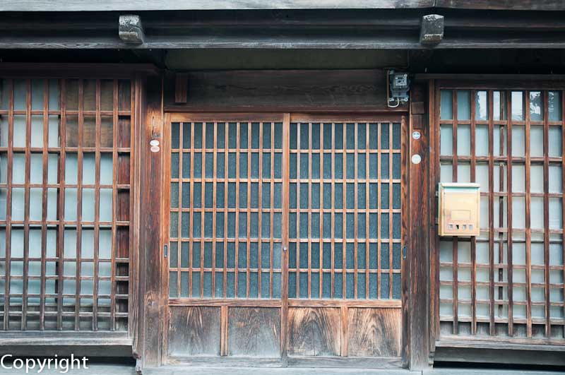 Latticed wooden screen doors and windows