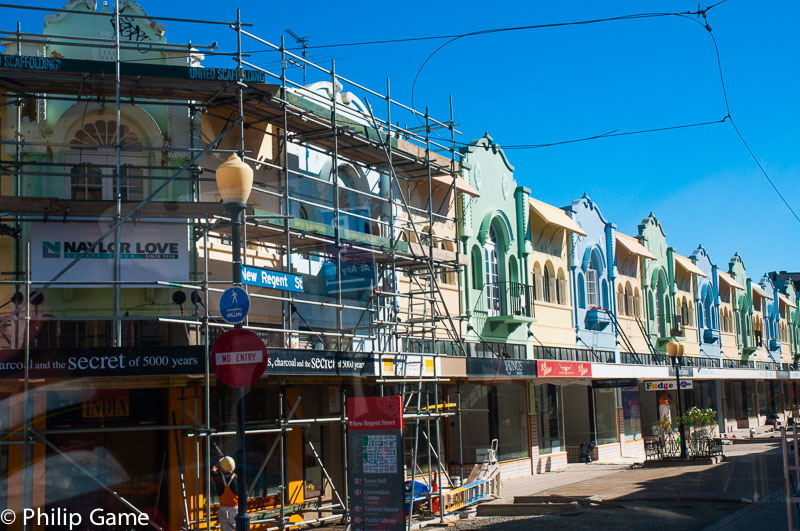 New Brighton Street is lined both sides with Spanish Mission two-storey shops, all now damaged  