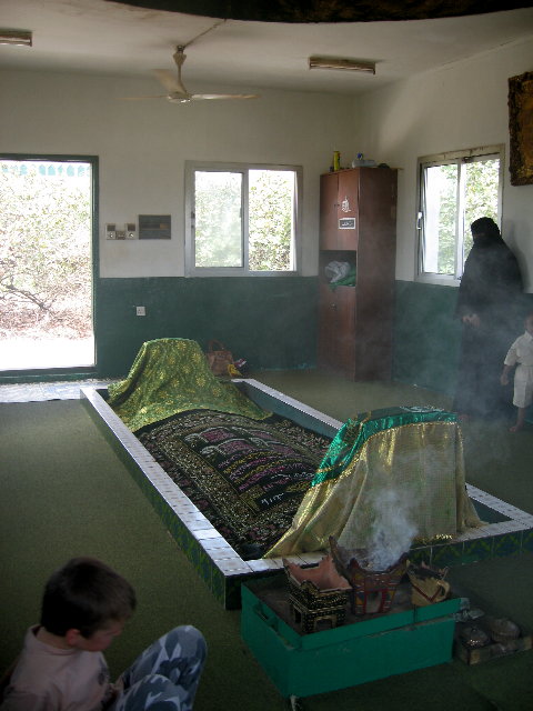 Inside to tomb.  There was a carpet over a mound of dirt with two end things.  They were burning frankincense.