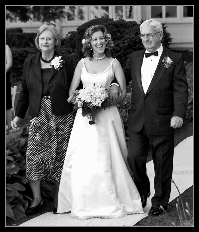 Happy Bride Escorted by Mom and Dad