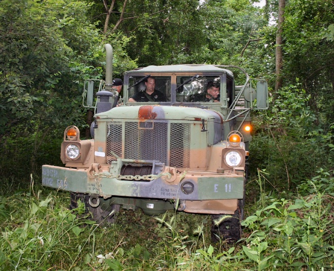 Duece and a half truck in woods.