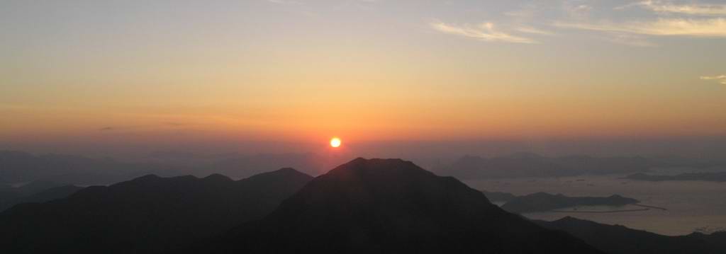 Sunrise on Lantau Peak.  The highest hill in photo is Sunset Peak.