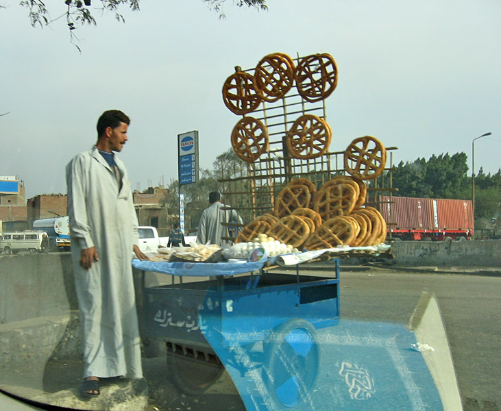 Selling fancy bread and eggs, on a street in Giza.