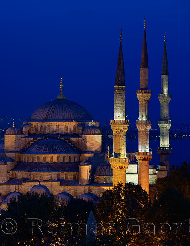 Three minarets of the lit Blue Mosque at dusk on the Bosphorus Sultanahmet Istanbul Turkey