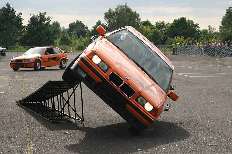 Girls inside stunts car on two wheels drive