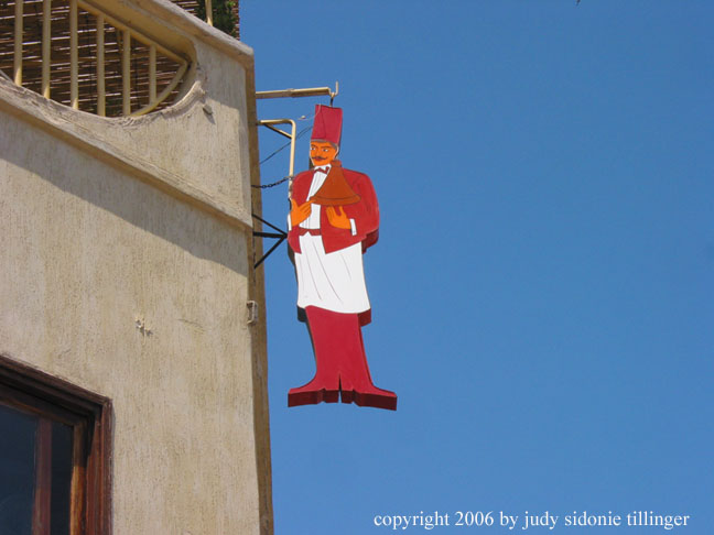 waiter sign and blue sky, rabat, morocco