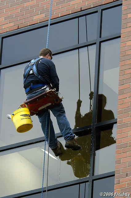 Washing windows during a break in the rain