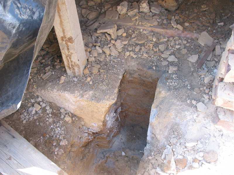 under the old fireplace