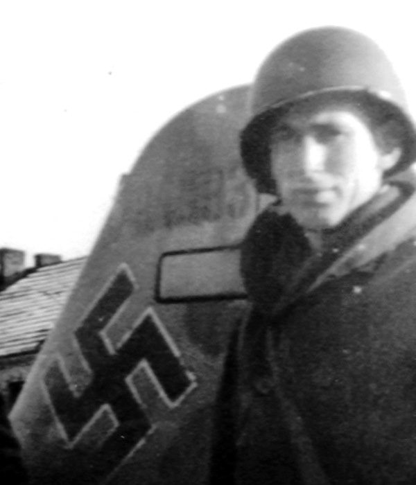 John Proctor of Battery A of the 455th AAA in front of the rudder, take a close look at the works number