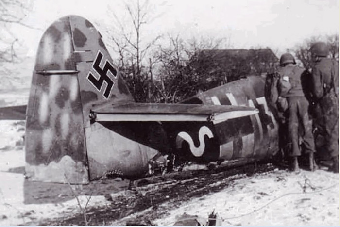 Interested GIs inspecting the cockpit area, note the light dots on the rudder